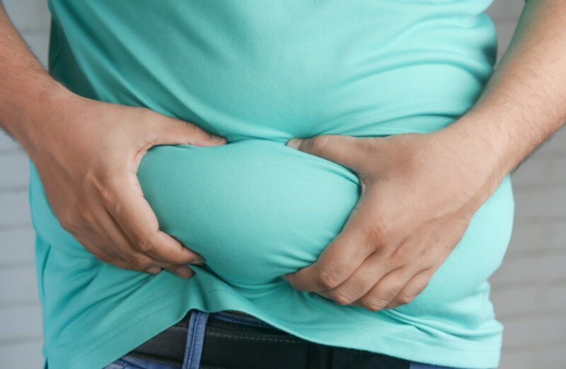 Fire in the Belly: When Your “Acidity” is Actually a Warning Sign a man holding his stomach with his hands